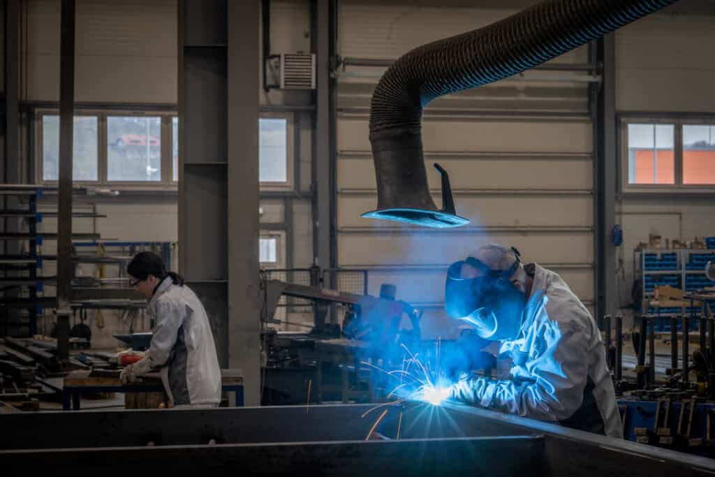 Welders Working In Factory