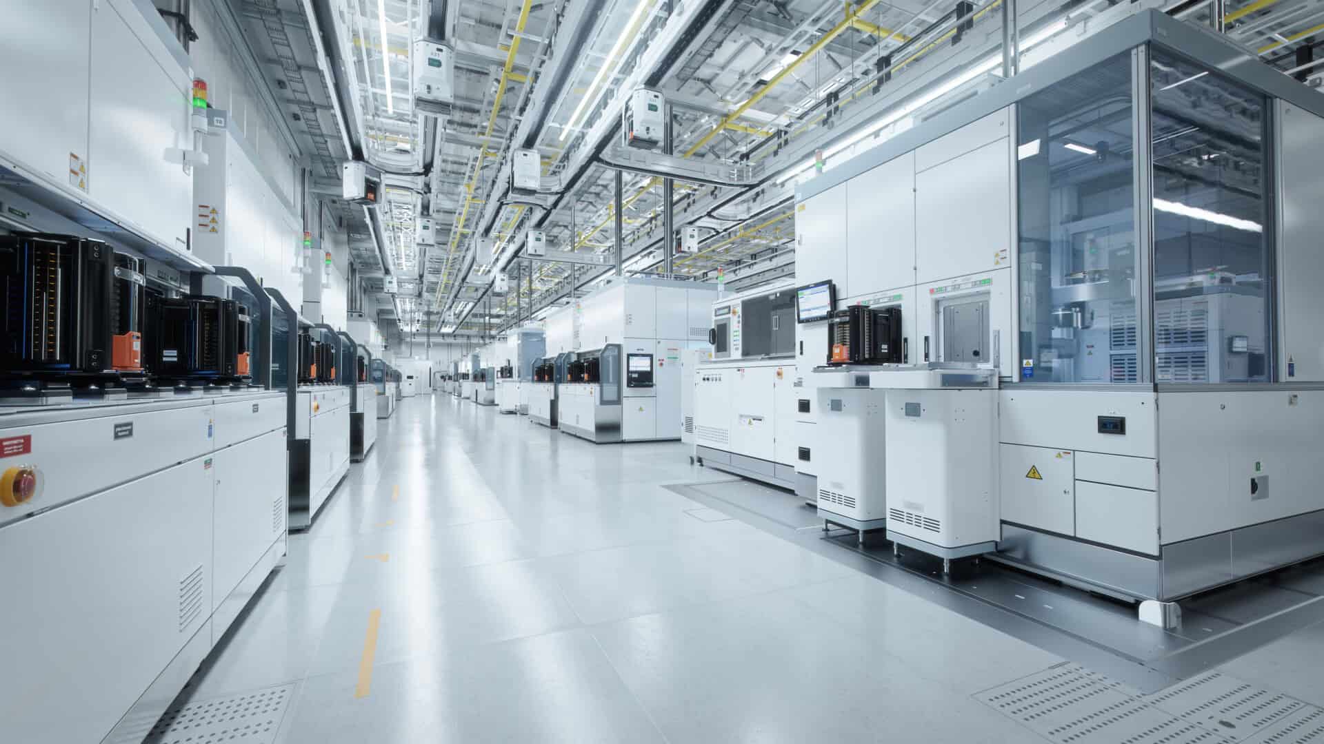 Wide Shot Of Bright Advanced Semiconductor Production Fab Cleanroom With Working Overhead Wafer Transfer System